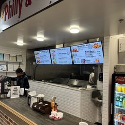 a man standing at the counter of a fast food restaurant