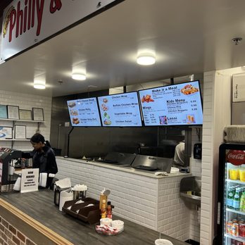 Philly & Wrap - a man standing at the counter of a fast food restaurant - Wraps Near Me - Marietta, Georgia