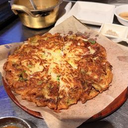 GAMJA JEON 바삭 감자전 Crispy potato pancake with squid, served with our secret spicy soy sauce.