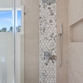 Luxe Remodeling - Detailed view of custom Kirkland shower with rainfall shower head, hand sprayer, built-in niche, and marble accent tile. - General Contractors Near Me Luxe Remodeling - Detailed view of custom Kirkland shower with rainfall shower head, hand sprayer, built-in niche, and marble accent tile. - General Contractors Near Me