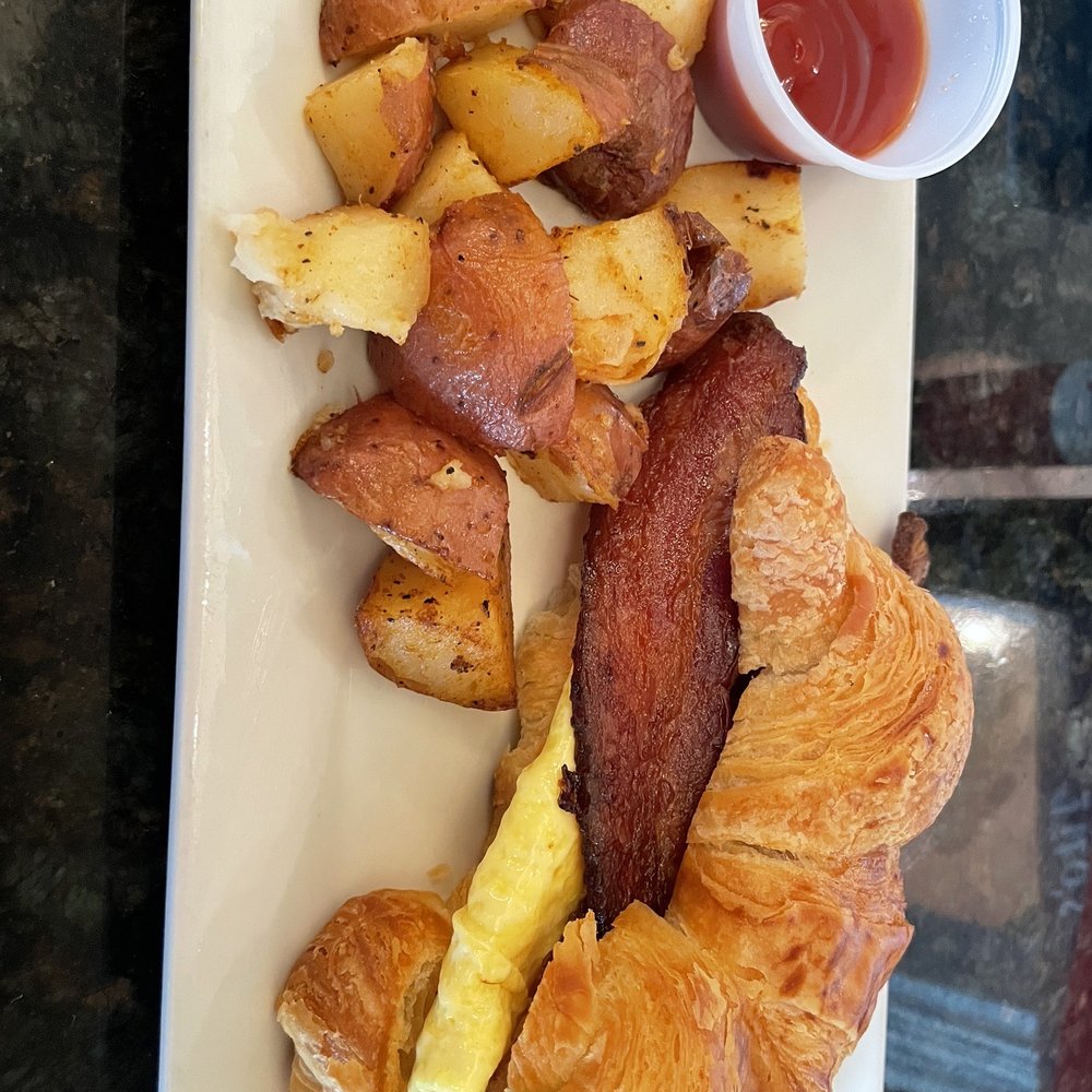 Prosecco Cafe - Egg , Meat & Cheese Croissant with Breakfast Potatoes - Breakfast & Brunch Near Me - Palm Beach Gardens, Florida Prosecco Cafe - Egg , Meat & Cheese Croissant with Breakfast Potatoes - Breakfast & Brunch Near Me - Palm Beach Gardens, Florida