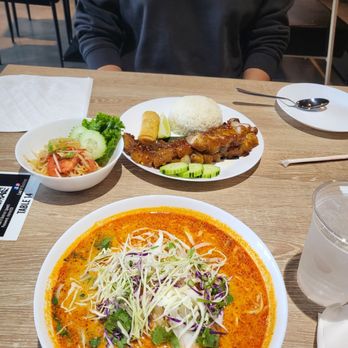 Lao'd District - Crack belly in back, papaya salad side to left, Curry-Coconut soup w/ vermicelli in foreground - Thai Near Me - Houston, Texas