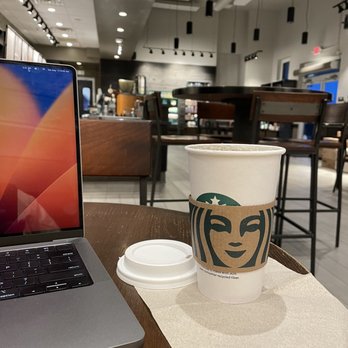 Starbucks - a cup of coffee next to a laptop - Coffee & Tea Near Me - Aurora, Ohio Starbucks - a cup of coffee next to a laptop - Coffee & Tea Near Me - Aurora, Ohio
