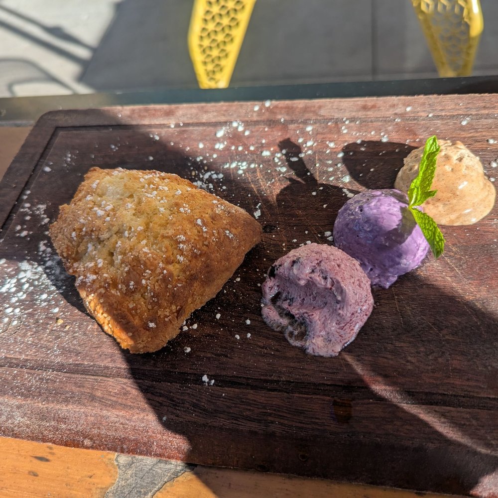 Public Square - Scone (with a bite missing) and blueberry, peanut butter ube, and cinnamon butter. - Coffee & Tea Near Me - La Mesa, California Public Square - Scone (with a bite missing) and blueberry, peanut butter ube, and cinnamon butter. - Coffee & Tea Near Me - La Mesa, California