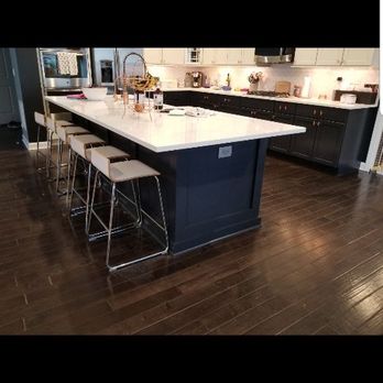 Top Notch Remodeling - a kitchen island with stools - General Contractors Near Me
