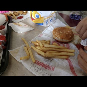 Burger King - a person eating a hamburger and french fries - Burgers Near Me - Madison, Indiana