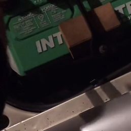 Battery held down by wood