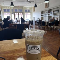 a cup of iced coffee on a table a cup of iced coffee on a table