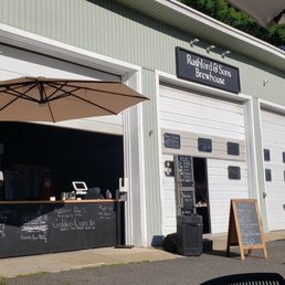 Sitting in the outdoor patio on a sunny day looking back to the bar and the brewery