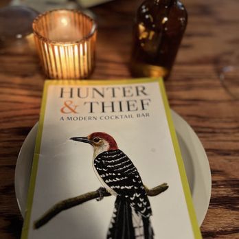 Hunter & Thief - a plate with a book on it - Cocktail Bars Near Me - Lindenhurst, New York