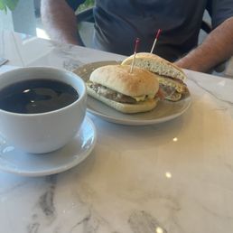 Husband's coffee and his sandwich.