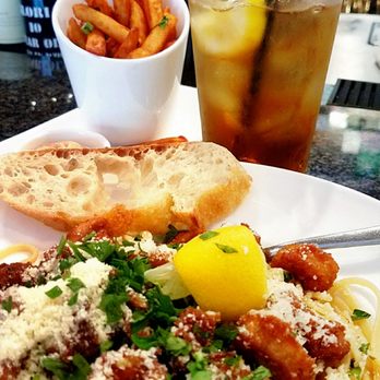 Fuzio Universal Bistro - Behold - the Calamari Linguini + extra garlic! Sriracha fries in the back as the costar! Delish. - New American Near Me - Modesto, California Fuzio Universal Bistro - Behold - the Calamari Linguini + extra garlic! Sriracha fries in the back as the costar! Delish. - New American Near Me - Modesto, California