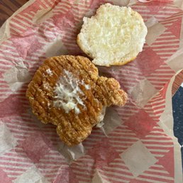 a fried chicken sandwich and a biscuit