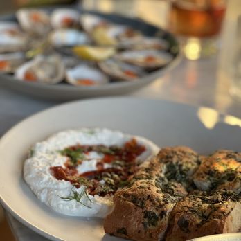 Daintree - Whipped lemon ricotta with pistachio chili oil with herbed focaccia - Cocktail Bars Near Me - New York, New York
