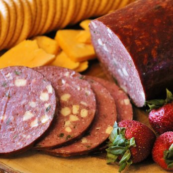Back Forty Beef - sliced sausage and strawberries on a cutting board - Meat Shops Near Me