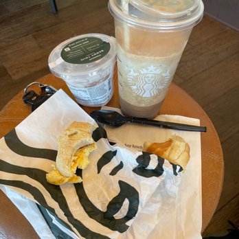 Starbucks - a cup of coffee and a sandwich on a table - Coffee & Tea Near Me - Lake Delton, Wisconsin