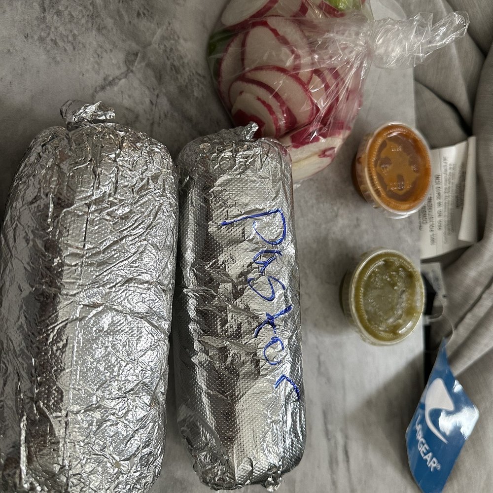 pastor and pollo burrito with salsa and radishes and limes
