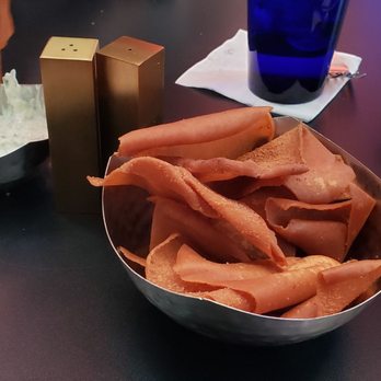 PIAF KITCHEN + WINE + BAR - Table complimentary chips (pita) - Mediterranean Near Me - Grapevine, Texas PIAF KITCHEN + WINE + BAR - Table complimentary chips (pita) - Mediterranean Near Me - Grapevine, Texas