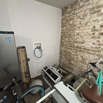 Prime Property Management - Old broken ac units and fridges stacked in common areas - Property Management Near Me