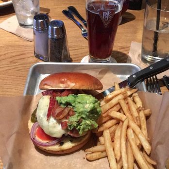 BJ's Restaurant & Brewhouse - Bacon guacamole deluxe burger and fries with Jeremiah Red tap beer. - New American Near Me - Fort Wayne, Indiana BJ's Restaurant & Brewhouse - Bacon guacamole deluxe burger and fries with Jeremiah Red tap beer. - New American Near Me - Fort Wayne, Indiana