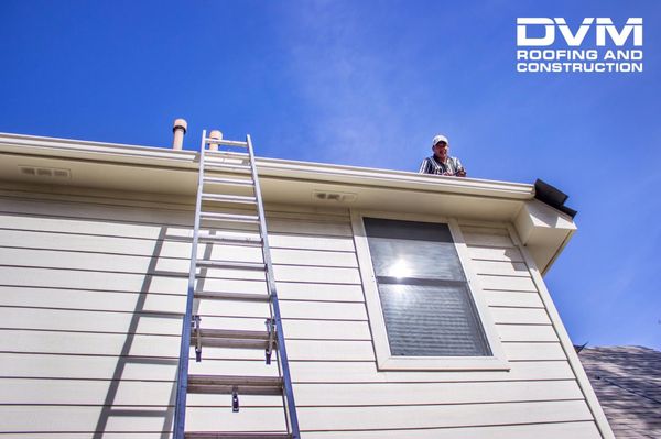 Dvm Roofing and Construction Logo