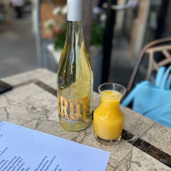 Ziziki's - a bottle of wine and a glass of orange juice - Greek Near Me - Dallas, Texas Ziziki's - a bottle of wine and a glass of orange juice - Greek Near Me - Dallas, Texas