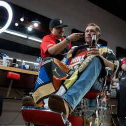 The Classic Barber - A man relaxes with a cold drink as George works on his fade