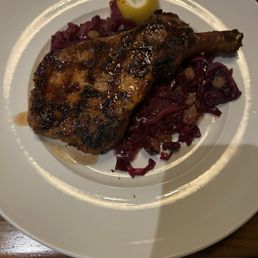 Pork chops with cabbage and white raisins.