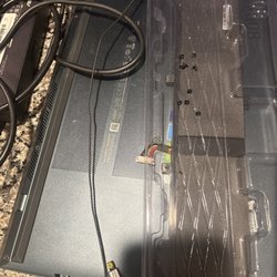 MP Repairs - Part should be inside the laptop but was carelessly thrown in the plastic battery container, 3 screws missing, panel not screwed in place