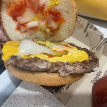 McDonald's - a hand holding a cheeseburger - Fast Food Near Me - Chesterfield, Virginia McDonald's - a hand holding a cheeseburger - Fast Food Near Me - Chesterfield, Virginia