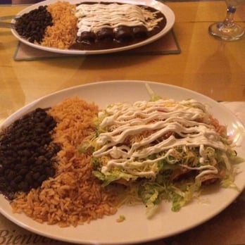 Paellas Cafe - One dish is flautas, and the other is chicken enchiladas with mole sauce - Mexican Near Me - Harrison, New Jersey
