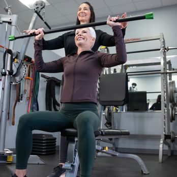 Fitness Together - Female client working with female personal working on upper body strength - Gyms Near Me - Burlington, Massachusetts Fitness Together - Female client working with female personal working on upper body strength - Gyms Near Me - Burlington, Massachusetts