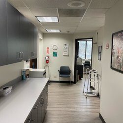 Leidos QTC Health Services - Clinic hallway with eye exam chart.