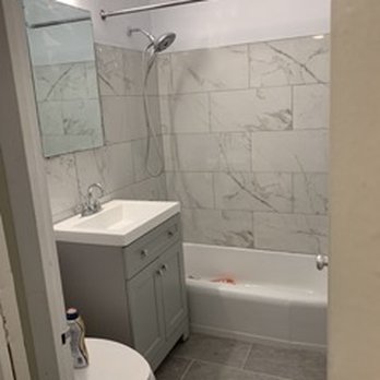 High Gloss Interiors - a bathroom with a sink, toilet, and bathtub - Flooring Near Me - Brooklyn, New York High Gloss Interiors - a bathroom with a sink, toilet, and bathtub - Flooring Near Me - Brooklyn, New York