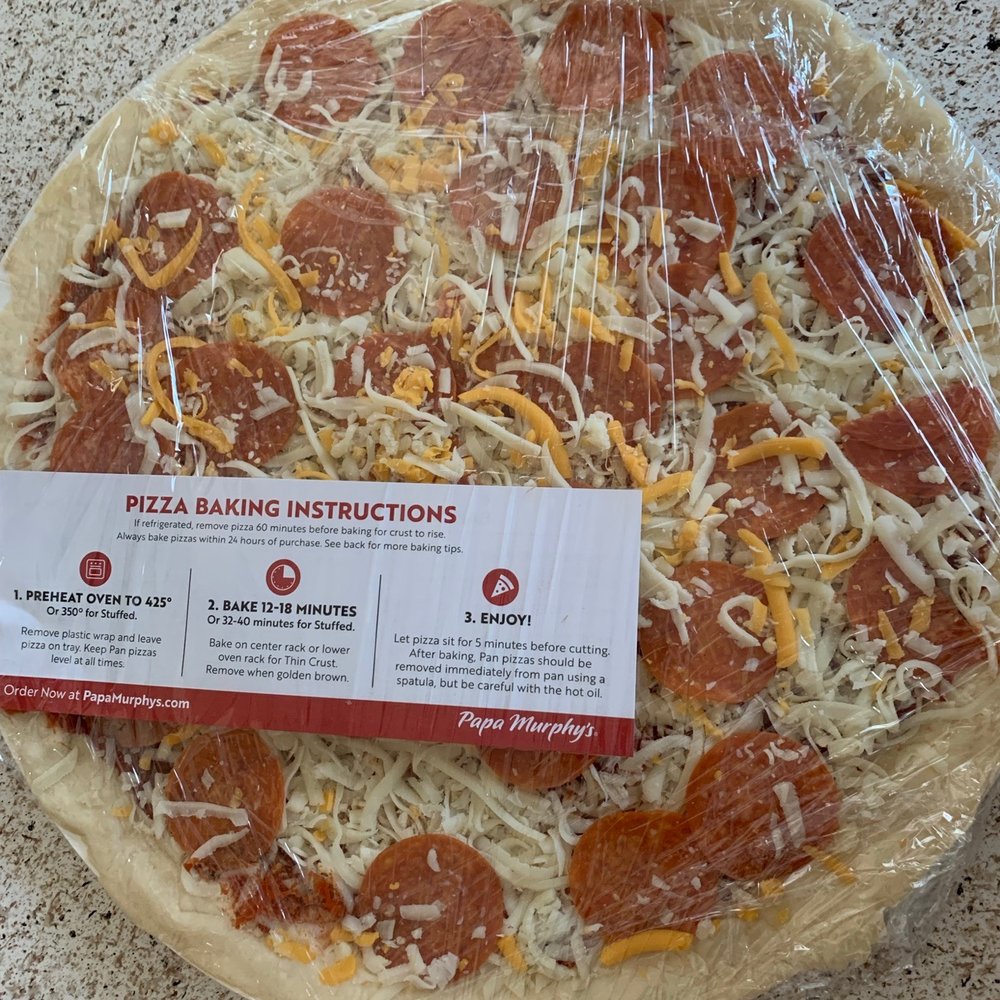 a pizza wrapped in plastic a pizza wrapped in plastic