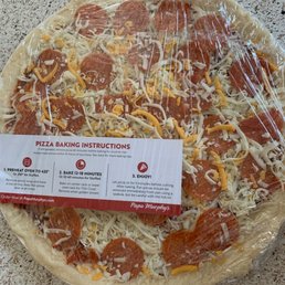 a pizza wrapped in plastic a pizza wrapped in plastic