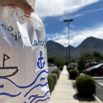 Nautical Bowls - a hand holding a bag of food - Acai Bowls Near Me - Oro Valley, Arizona Nautical Bowls - a hand holding a bag of food - Acai Bowls Near Me - Oro Valley, Arizona