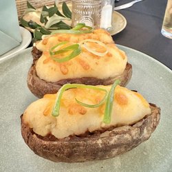 Olea Fusion Bistro - Potato skins filled with lamb, peas, carrots, and herbs. Topped with cheddar cheese.