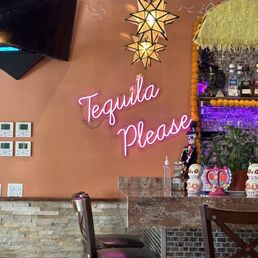 a bar with a neon sign that says tequila please a bar with a neon sign that says tequila please