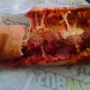 Subway - a half eaten meatball sandwich on a wrapper - Sandwiches Near Me - Hallsville, Texas