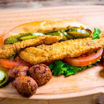 Rollin Smoke BBQ - Catfish Po' Boy - Crispy fried catfish with lettuce, tomato & pickles on a bun. Served with hush puppies.. - Barbeque Near Me - Avondale, Arizona Rollin Smoke BBQ - Catfish Po' Boy - Crispy fried catfish with lettuce, tomato & pickles on a bun. Served with hush puppies.. - Barbeque Near Me - Avondale, Arizona