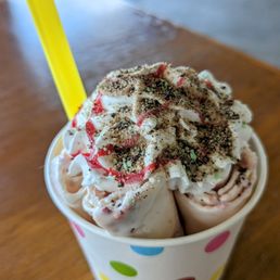 rolled ice cream, vanilla base with strawberries and banana and whipped cream rolled ice cream, vanilla base with strawberries and banana and whipped cream