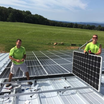Independent Solar Solutions - two men installing solar panels on a roof - Solar Installation Near Me Independent Solar Solutions - two men installing solar panels on a roof - Solar Installation Near Me