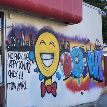 Happy Donuts - This sign is funny and almost threw me off basically saying we couldn't park here? Lol I get it though! - Donuts Near Me - Oakland, California