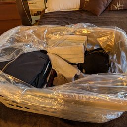 The folded laundry in a plastic bag in our provided laundry basket.