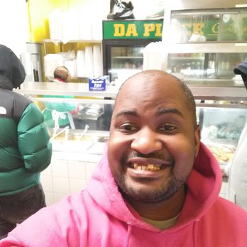 Da Place Cuisine - a man in a pink hoodie - Caribbean Near Me - Brooklyn, New York