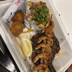 Biscuits Steakhouse - Ribeye steak with shrimp skewer, and loaded baked potato.