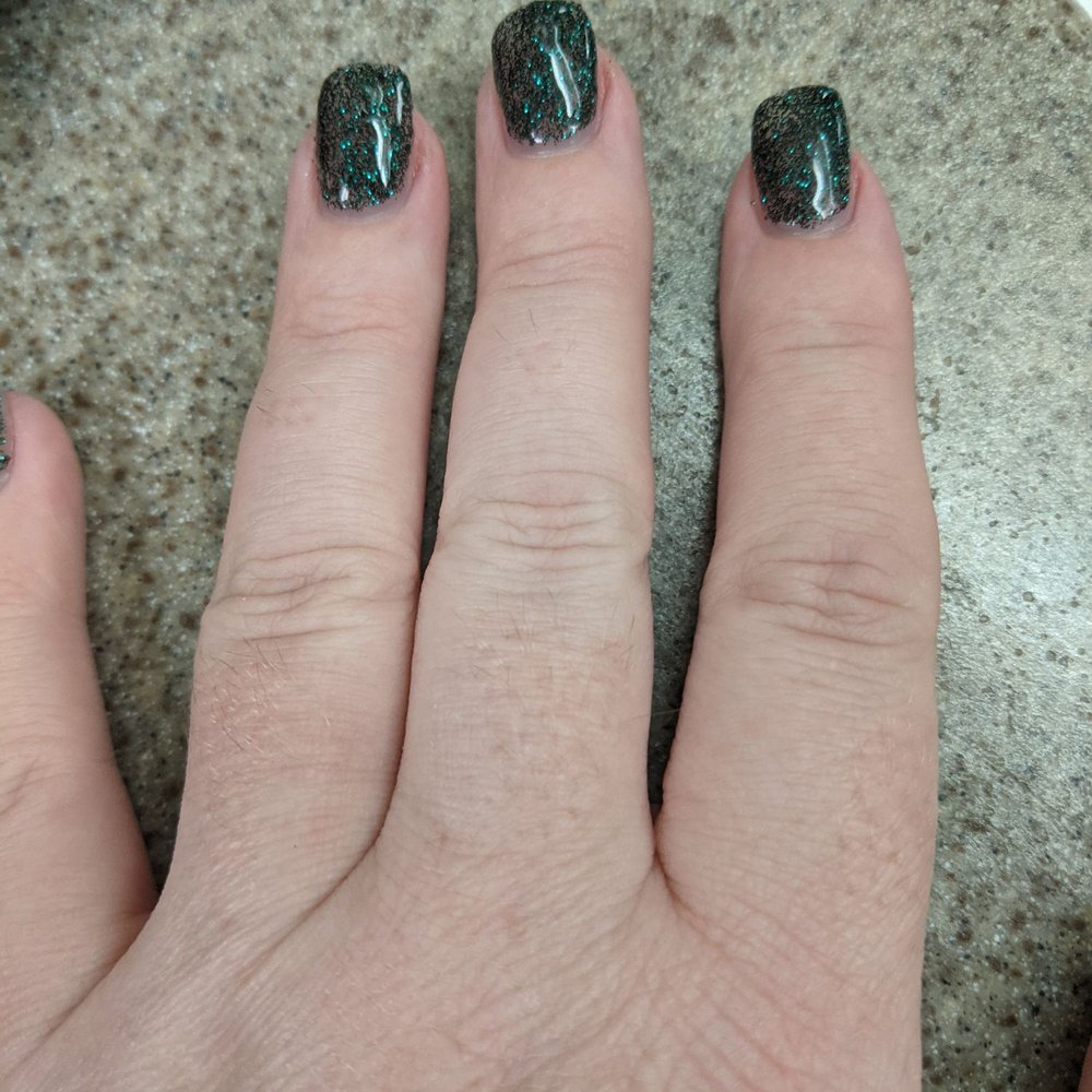 The manicure I got, which I absolutely love. Dark green sparkly nails. The manicure I got, which I absolutely love. Dark green sparkly nails.