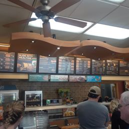 a large group of people waiting in line to order food a large group of people waiting in line to order food