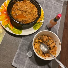 a bowl of chili and a bowl of cornflakes on a table a bowl of chili and a bowl of cornflakes on a table